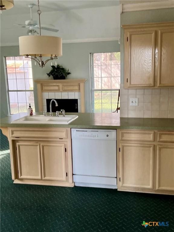 kitchen with ceiling fan, white dishwasher, a sink, light countertops, and tasteful backsplash