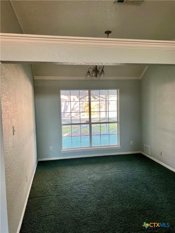 empty room featuring ornamental molding, carpet, visible vents, and baseboards