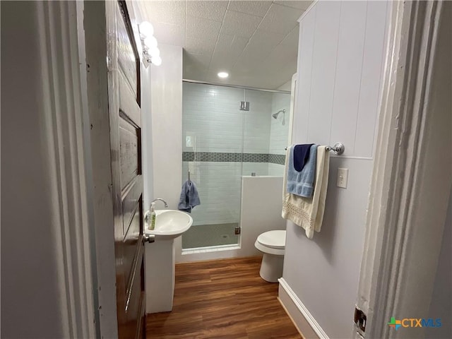 1203 E Third St, Hallettsville, TX 77954 - full bathroom featuring wood finished floors, a stall shower, toilet, baseboards, and recessed lighting