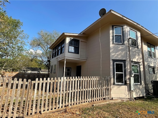 view of side of property featuring central AC