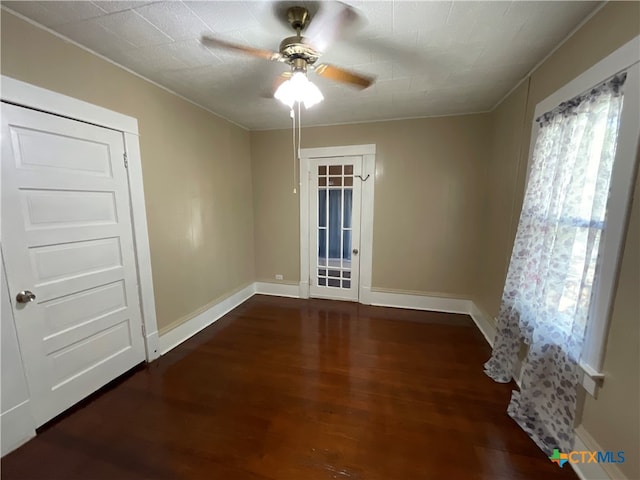 spare room featuring ornamental molding, dark hardwood / wood-style floors, and ceiling fan