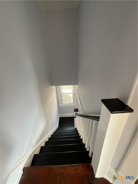 stairway featuring hardwood / wood-style flooring