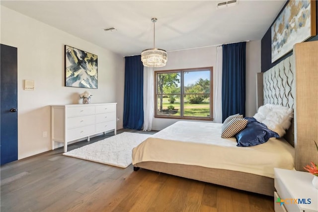 2406 Northwoods Dr, New Braunfels, TX 78132 - bedroom with a chandelier and wood finished floors