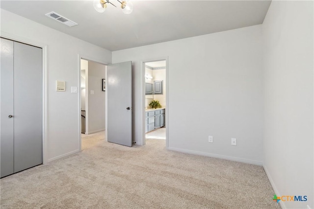 2406 Northwoods Dr, New Braunfels, TX 78132 - unfurnished bedroom featuring light colored carpet, a closet, and ensuite bath