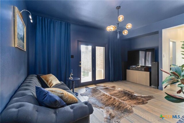 2406 Northwoods Dr, New Braunfels, TX 78132 - living area featuring wood finished floors, french doors, and a chandelier