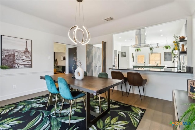 2406 Northwoods Dr, New Braunfels, TX 78132 - dining area featuring wood finished floors and a chandelier