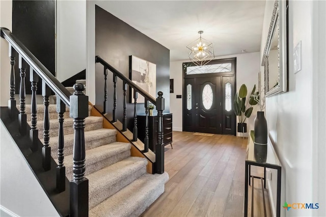 2406 Northwoods Dr, New Braunfels, TX 78132 - entryway featuring wood-type flooring, stairs, and a chandelier