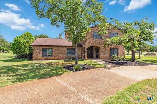 2406 Northwoods Dr, New Braunfels, TX 78132 - traditional-style house with brick siding and a front yard