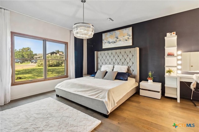 2406 Northwoods Dr, New Braunfels, TX 78132 - bedroom with a chandelier and wood finished floors