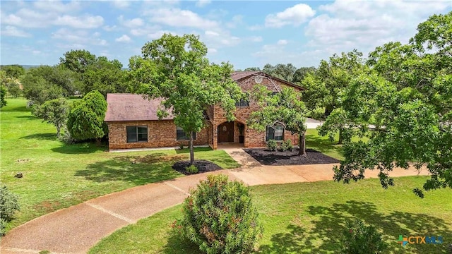 2406 Northwoods Dr, New Braunfels, TX 78132 - view of front facade with a front lawn and brick siding