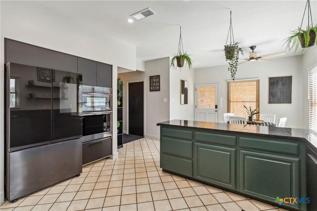 2406 Northwoods Dr, New Braunfels, TX 78132 - kitchen featuring smart refrigerator, ceiling fan, dark countertops, green cabinetry, and light tile patterned floors