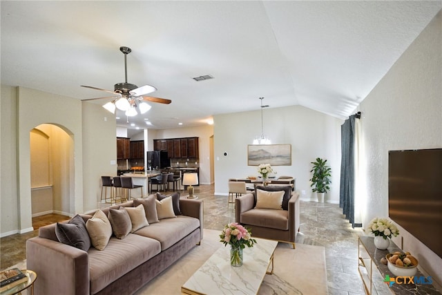 living room with ceiling fan and lofted ceiling