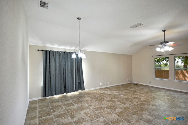 empty room with ceiling fan with notable chandelier, lofted ceiling, and a textured ceiling