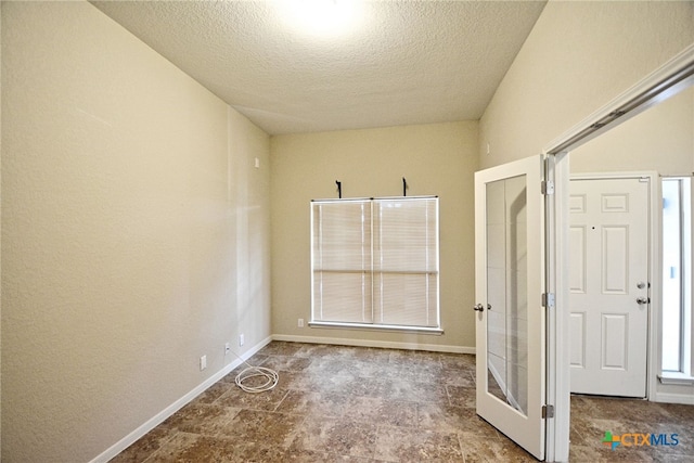 empty room with a textured ceiling