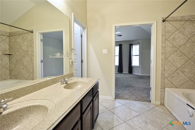 bathroom featuring vanity, tile patterned floors, and tiled shower / bath