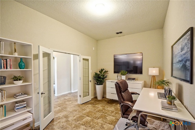 office with a textured ceiling and french doors