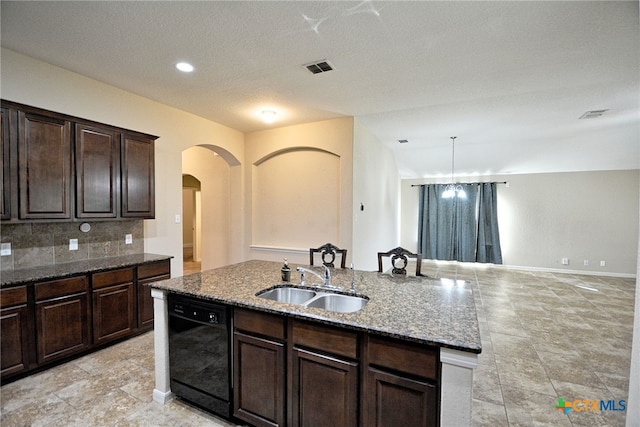 kitchen with pendant lighting, dishwasher, backsplash, a center island with sink, and sink