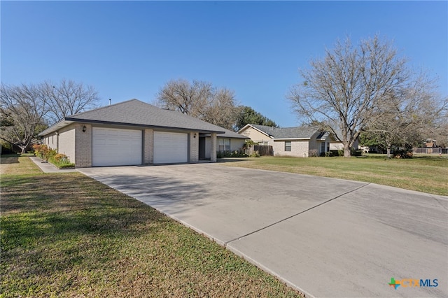 ranch-style house featuring a front yard and a garage