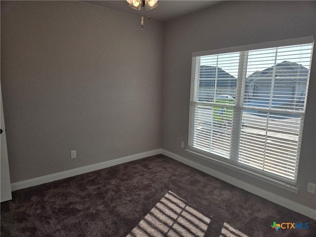 spare room with carpet and baseboards