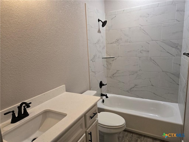 full bath featuring toilet,  shower combination, and a textured wall