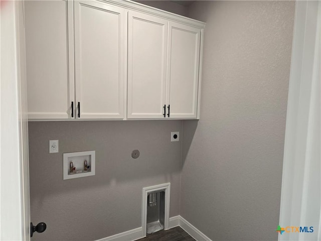 laundry area with cabinet space, baseboards, dark wood-style flooring, hookup for a washing machine, and electric dryer hookup