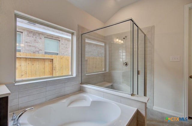 bathroom with vanity, lofted ceiling, and plus walk in shower