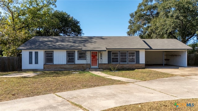 ranch-style house with a carport and a front yard