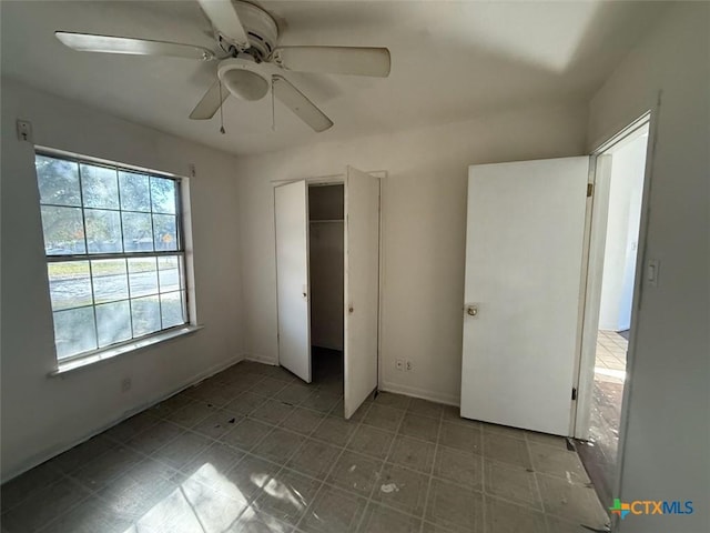 unfurnished bedroom featuring a closet and ceiling fan