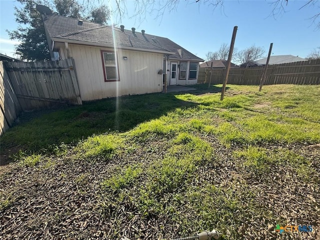 rear view of house with a yard