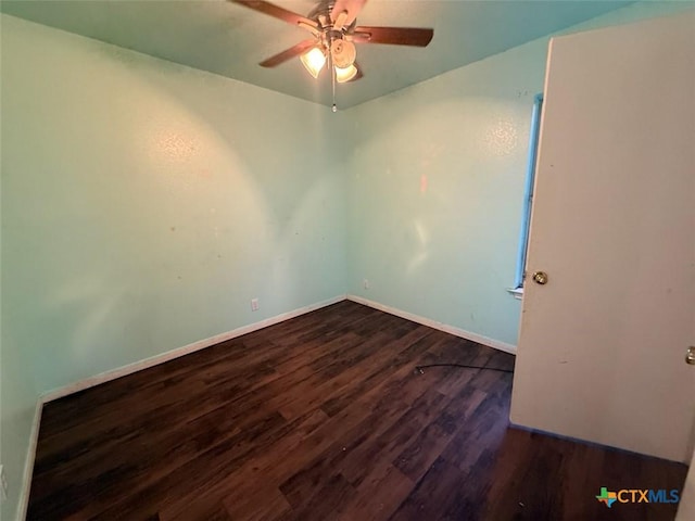 empty room with ceiling fan and dark hardwood / wood-style floors