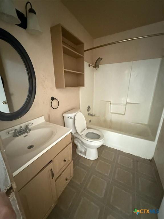 full bathroom featuring toilet, washtub / shower combination, and vanity