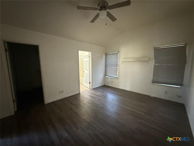 unfurnished bedroom with vaulted ceiling, ceiling fan, dark hardwood / wood-style floors, ensuite bath, and a spacious closet