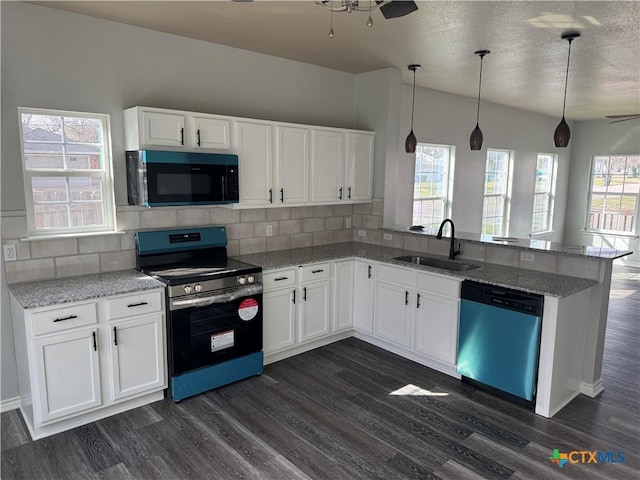 kitchen featuring ceiling fan, dishwasher, a peninsula, stainless steel range with electric stovetop, and a sink