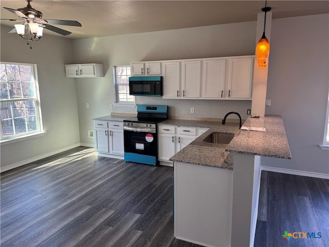 kitchen featuring black microwave, stainless steel electric range oven, a peninsula, white cabinetry, and a sink