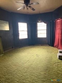 carpeted empty room featuring ceiling fan