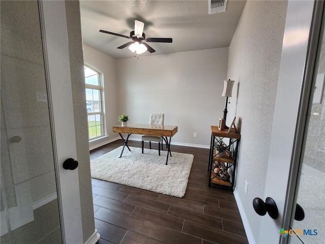 office space featuring ceiling fan and dark wood-type flooring