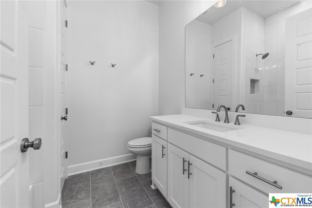 bathroom with tile patterned floors, vanity, toilet, and walk in shower