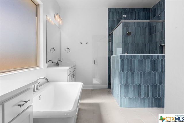 bathroom with tile patterned flooring, vanity, and independent shower and bath