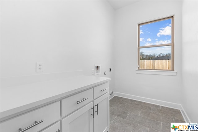 washroom with electric dryer hookup, cabinets, and hookup for a washing machine