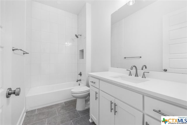 full bathroom with tile patterned floors, vanity, toilet, and tiled shower / bath