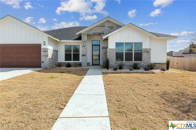 view of front of house with a front yard and a garage