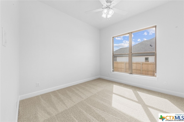 carpeted spare room with ceiling fan