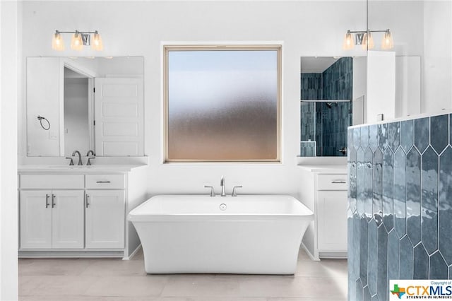 bathroom with tile patterned floors, vanity, and independent shower and bath