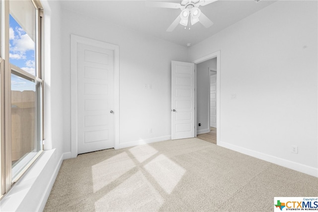 unfurnished bedroom featuring ceiling fan and light carpet