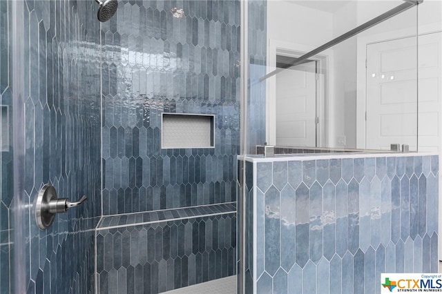 bathroom with a tile shower