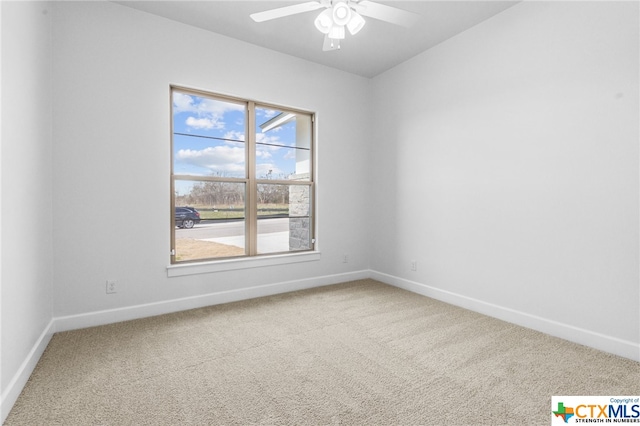 carpeted spare room featuring ceiling fan and a healthy amount of sunlight