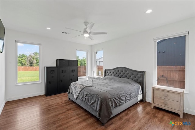 bedroom featuring ceiling fan, baseboards, wood finished floors, and visible vents