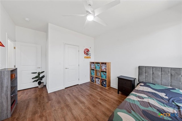 bedroom with baseboards, a ceiling fan, and wood finished floors