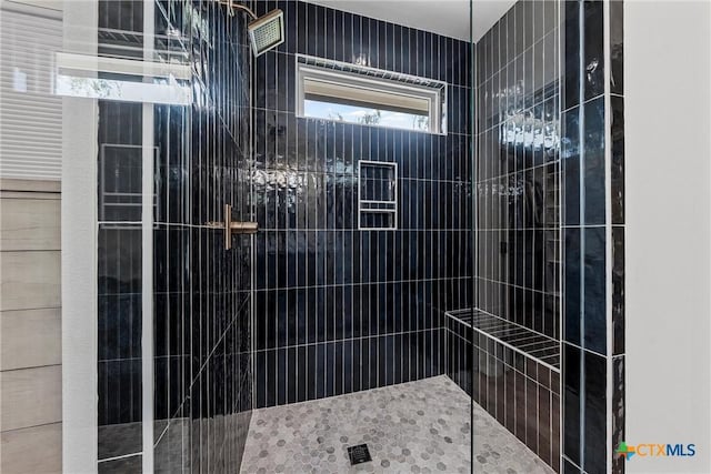 full bathroom with tiled shower