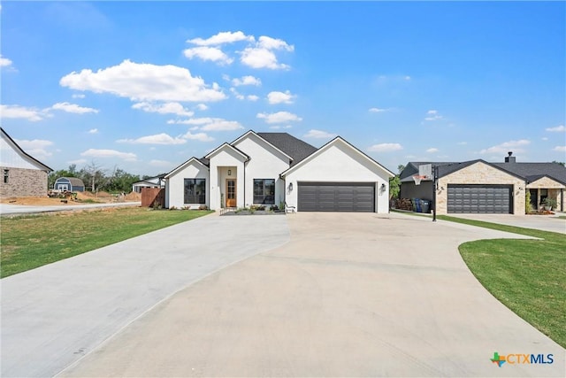 modern farmhouse with a garage, driveway, and a front lawn